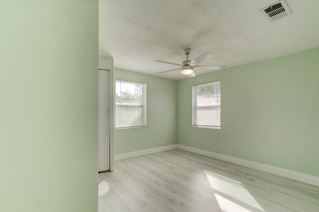 404 Adele Street Edgewater, FL 32132 - Photo 11 of 23 an empty room with windows and fan