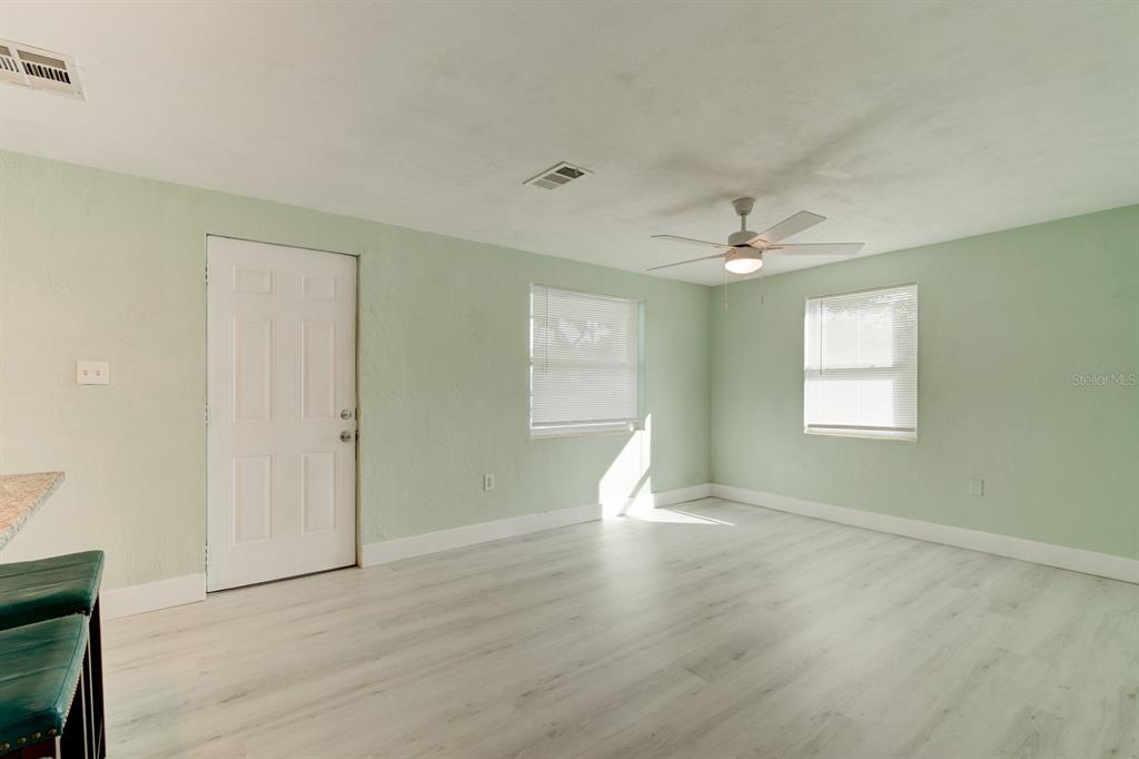 404 Adele Street Edgewater, FL 32132 - Photo 14 of 23 a view of an empty room with wooden floor and a window