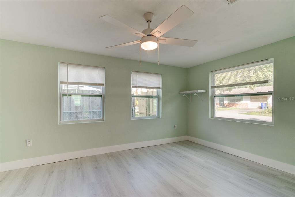 404 Adele Street Edgewater, FL 32132 - Photo 15 of 23 a view of an empty room with wooden floor and a window