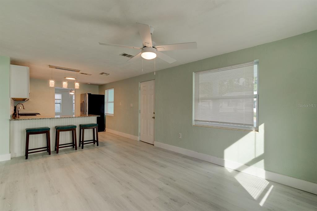404 Adele Street Edgewater, FL 32132 - Photo 3 of 23 a view of an empty room with kitchen and window