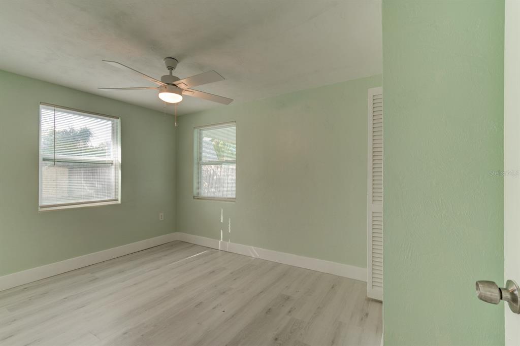 404 Adele Street Edgewater, FL 32132 - Photo 9 of 23 a view of empty room with wooden floor and fan