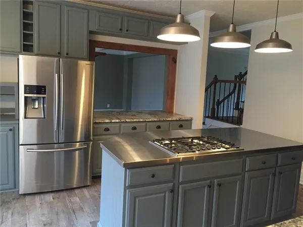 a kitchen with stainless steel appliances granite countertop a sink stove and refrigerator