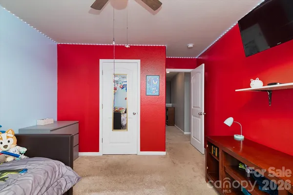 a bedroom with a bed and a mirror