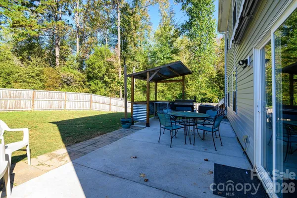 a view of a backyard with a patio and outdoor seating