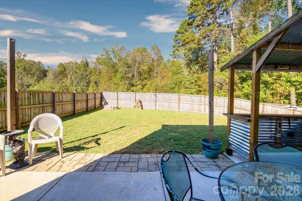 a view of a patio with a table chairs and a backyard