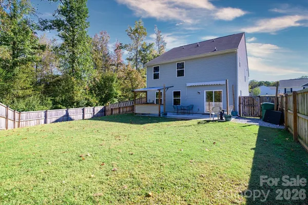 a backyard of a house with yard and outdoor seating
