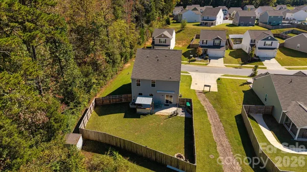 an aerial view of residential houses with outdoor space