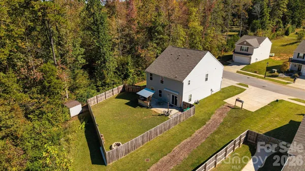 an aerial view of a house with a yard