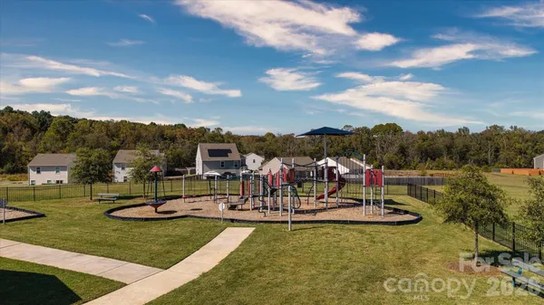 a view of a park with swings and slides