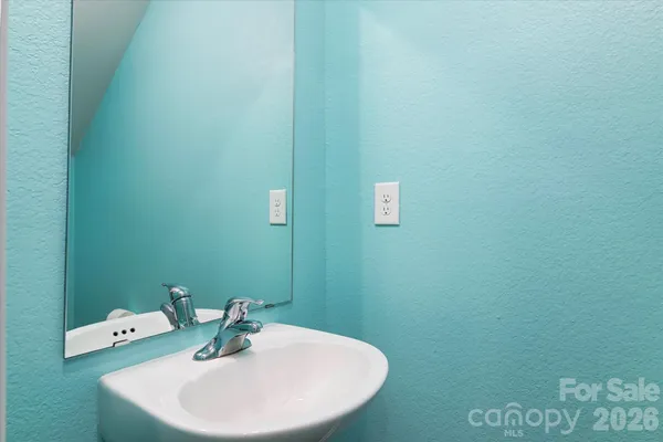 a bathroom with a sink and mirror