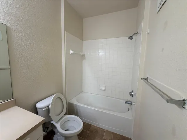 a bathroom with a toilet and a bathtub
