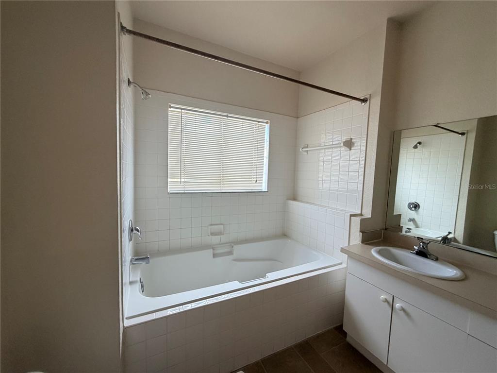 3561 Conroy Road, Unit 231 Orlando, FL 32839 - Photo 14 of 19 a bathroom with a bathtub and a sink