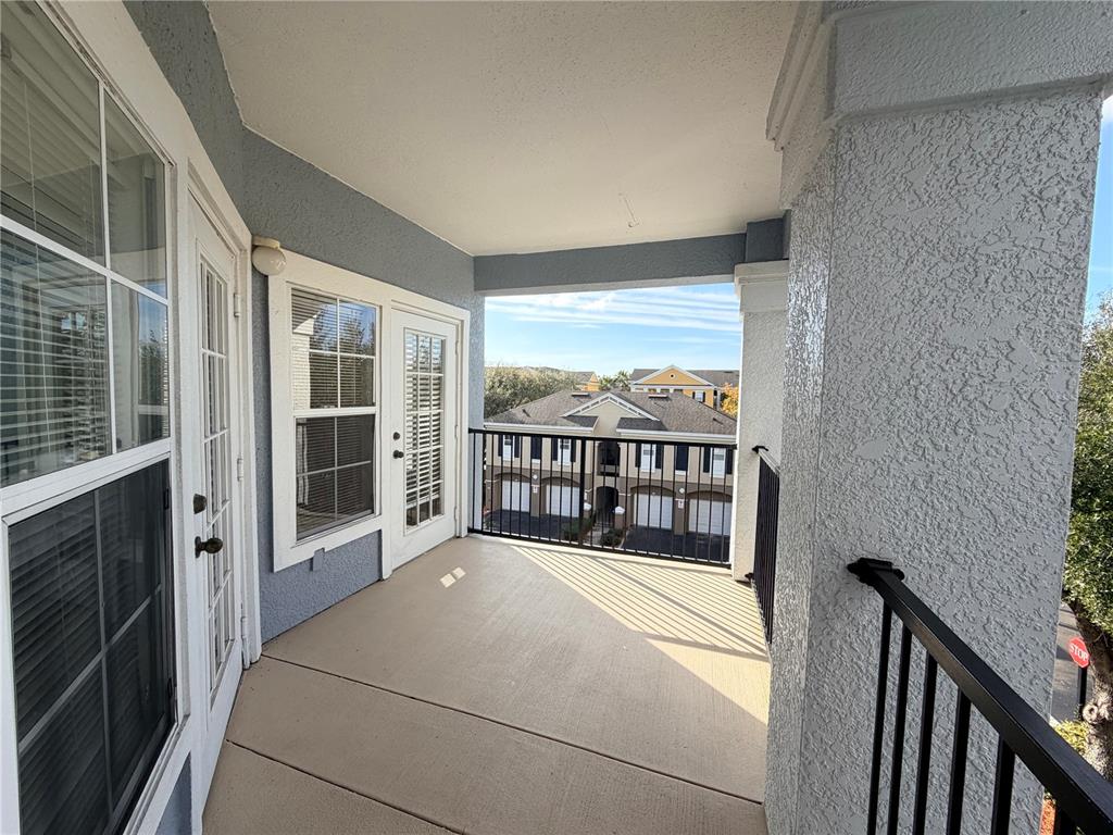 3561 Conroy Road, Unit 231 Orlando, FL 32839 - Photo 16 of 19 a view of balcony with a floor to ceiling window and stairs
