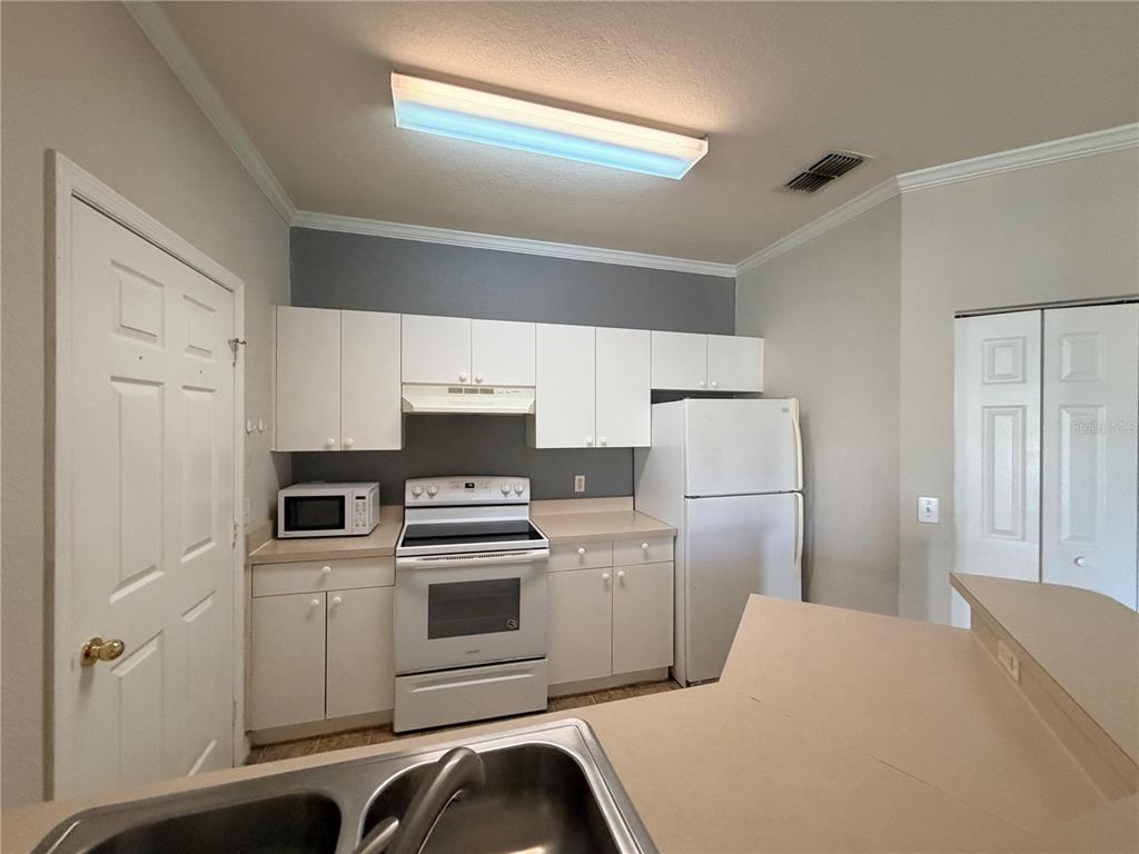 3561 Conroy Road, Unit 231 Orlando, FL 32839 - Photo 5 of 19 a kitchen with a refrigerator sink and stove