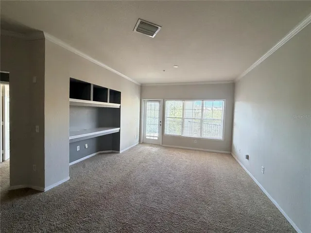 a view of empty room with closet and fireplace