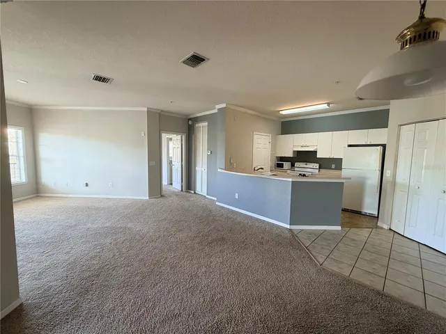 a view of kitchen with refrigerator stove microwave and cabinets