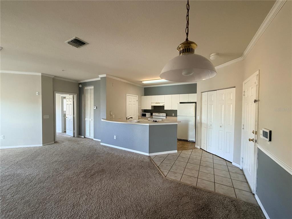 3561 Conroy Road, Unit 231 Orlando, FL 32839 - Photo 10 of 19 a open kitchen with kitchen island a sink stainless steel appliances and cabinets