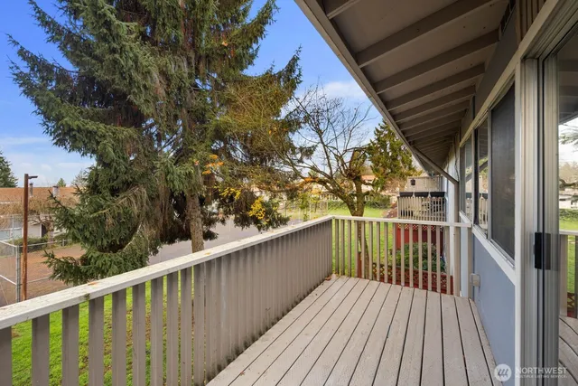 a view of balcony with wooden floor and fence