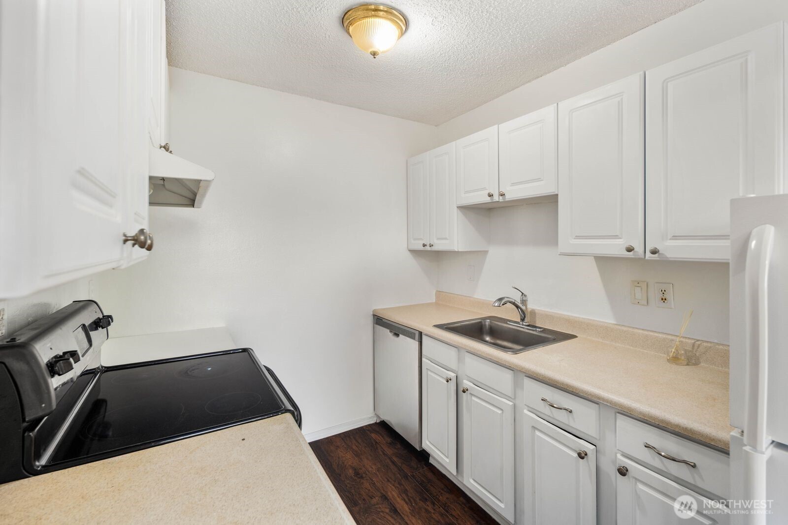 9623 South 248th Street, Unit C8 Kent, WA 98030 - Photo 14 of 37 a kitchen with a sink and cabinets