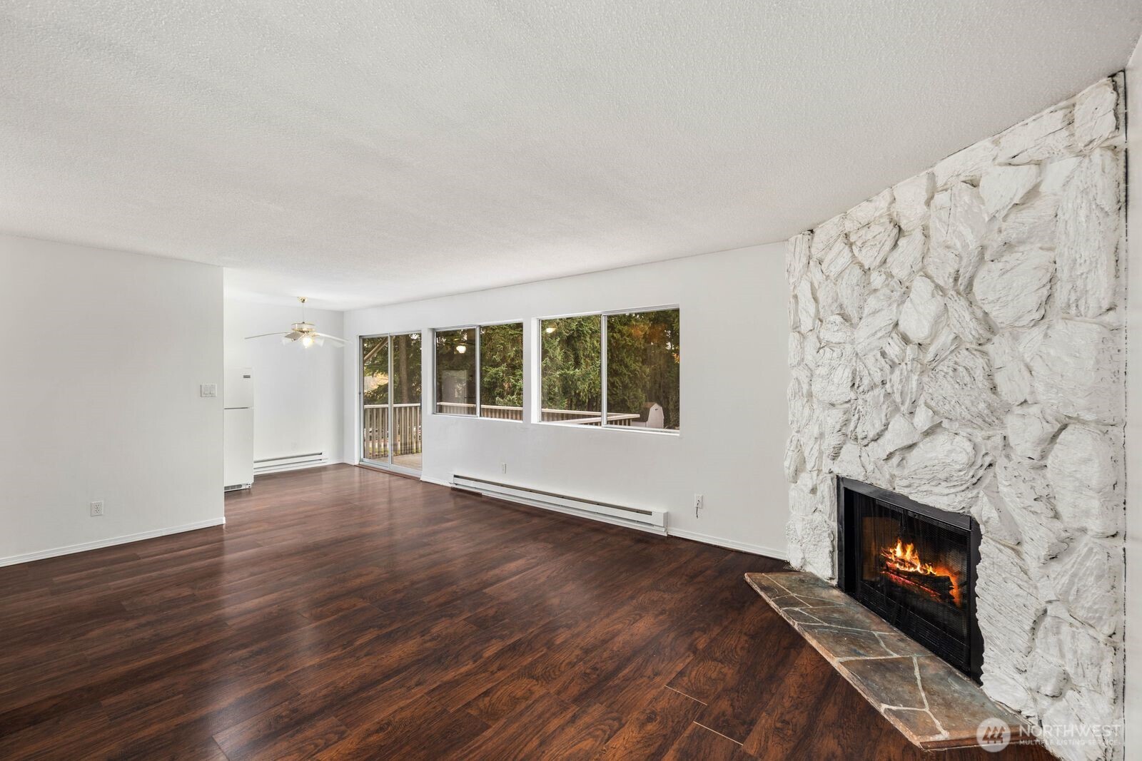 9623 South 248th Street, Unit C8 Kent, WA 98030 - Photo 3 of 37 a view of an empty room with wooden floor fireplace and a window
