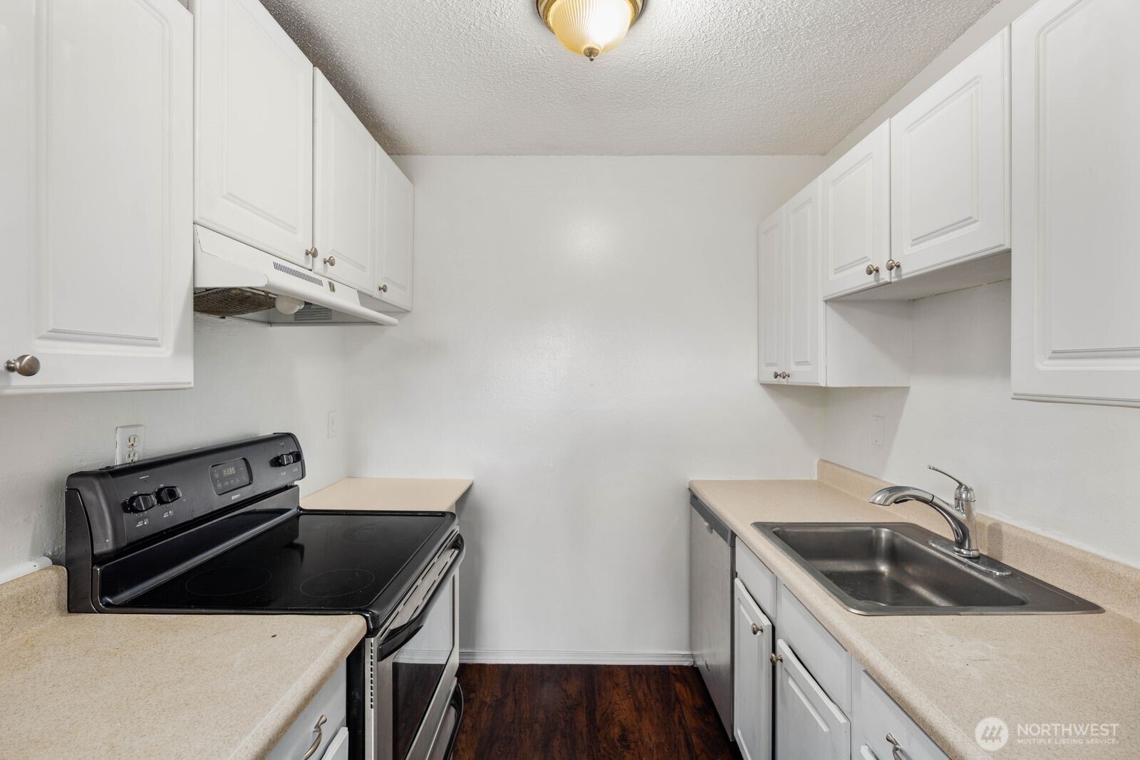 9623 South 248th Street, Unit C8 Kent, WA 98030 - Photo 4 of 37 a kitchen with stainless steel appliances granite countertop a sink stove and white cabinets