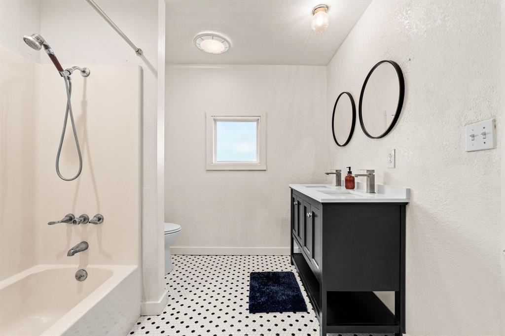 1550 South Stewart Street Azle, TX 76020 - Photo 24 of 35 a bathroom with a sink a toilet and a bathtub