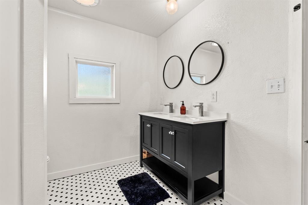 1550 South Stewart Street Azle, TX 76020 - Photo 25 of 35 a bathroom with a sink and a mirror