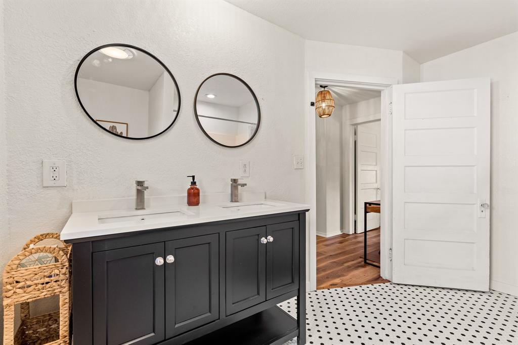 1550 South Stewart Street Azle, TX 76020 - Photo 26 of 35 a bathroom with a double vanity sink and a mirror