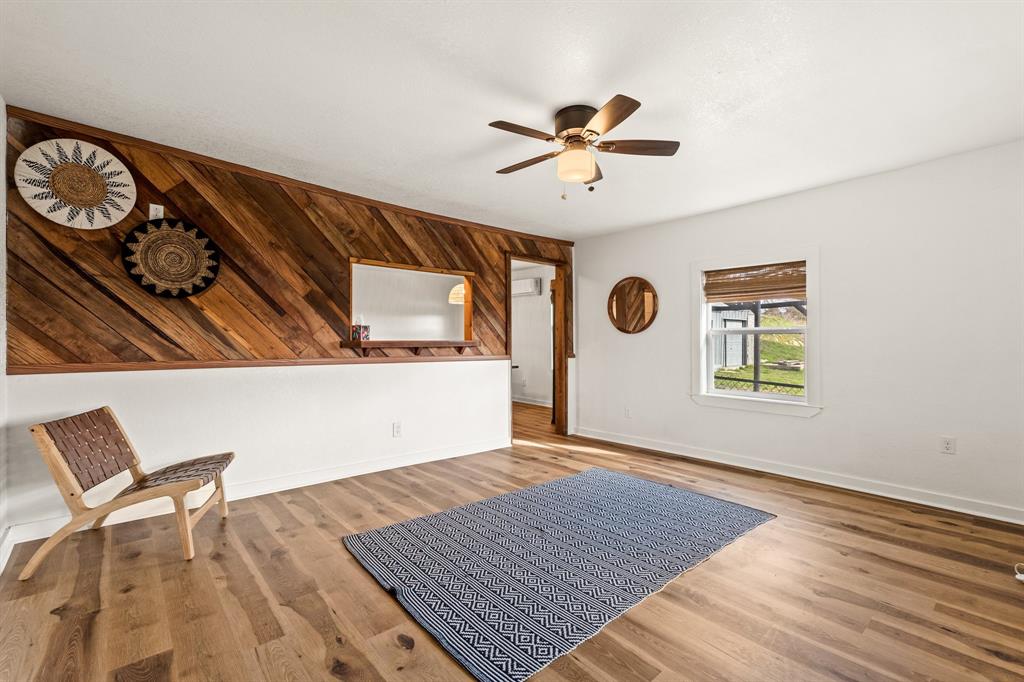 1550 South Stewart Street Azle, TX 76020 - Photo 7 of 35 a view of an empty room with window and wooden floor
