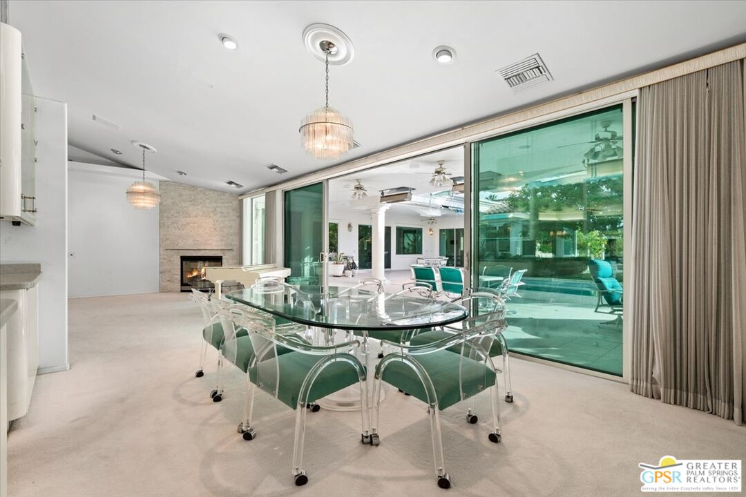 875 Tamarisk Road Palm Springs, CA 92262 - Photo 13 of 55 a view of a dining room with furniture window and outside view