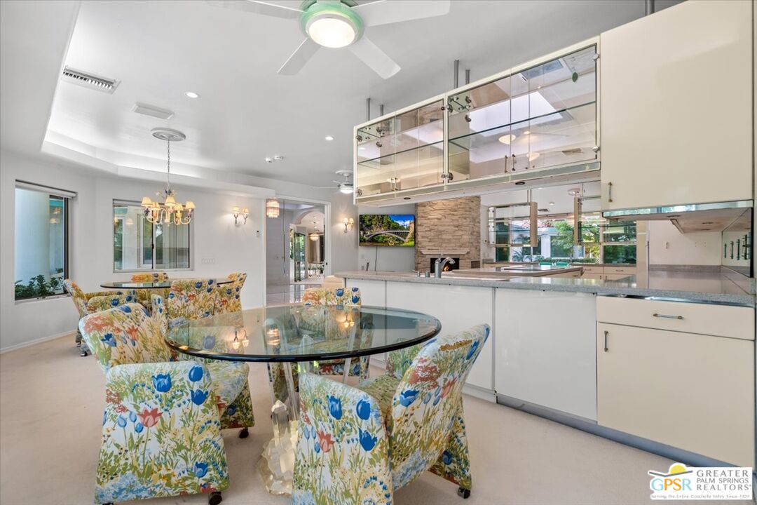 875 Tamarisk Road Palm Springs, CA 92262 - Photo 16 of 55 a dining table with chairs and a table