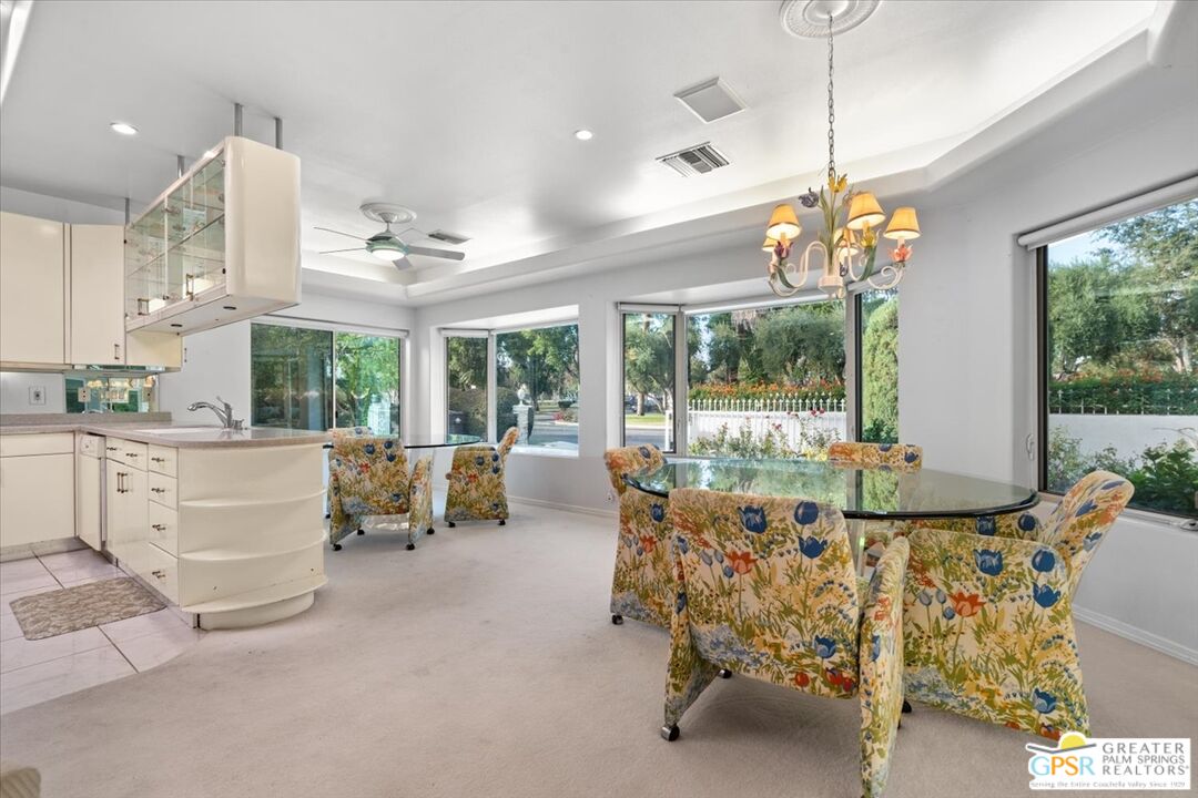 875 Tamarisk Road Palm Springs, CA 92262 - Photo 17 of 55 a living room with furniture chandelier and large windows
