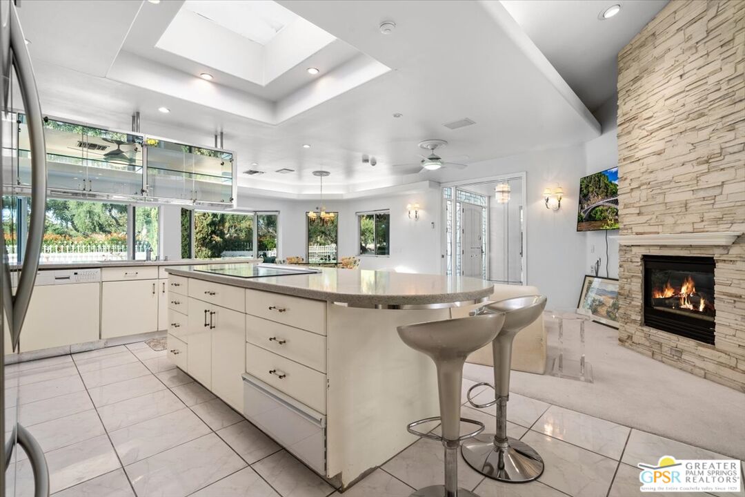 875 Tamarisk Road Palm Springs, CA 92262 - Photo 18 of 55 a kitchen with stainless steel appliances kitchen island granite countertop a sink and cabinets