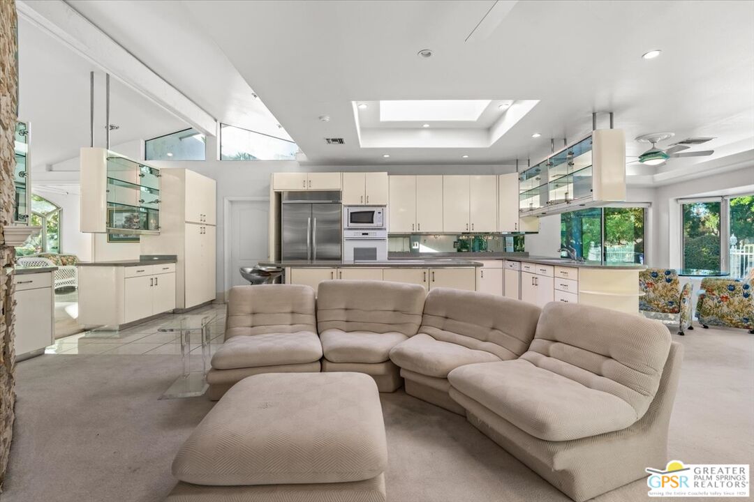 875 Tamarisk Road Palm Springs, CA 92262 - Photo 19 of 55 a view of a living room kitchen and a large window