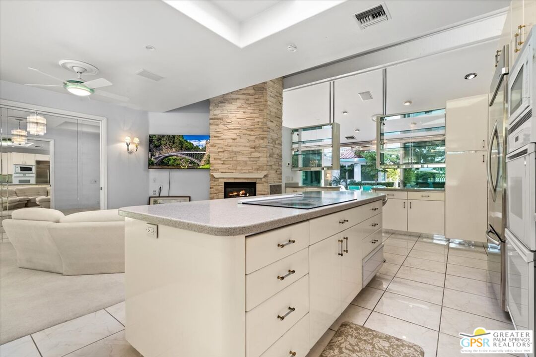875 Tamarisk Road Palm Springs, CA 92262 - Photo 20 of 55 a kitchen with counter top space and windows