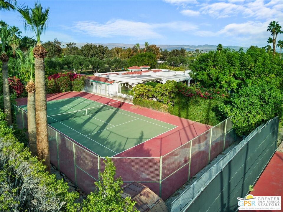 875 Tamarisk Road Palm Springs, CA 92262 - Photo 2 of 55 a view of a tennis ground with a swimming pool