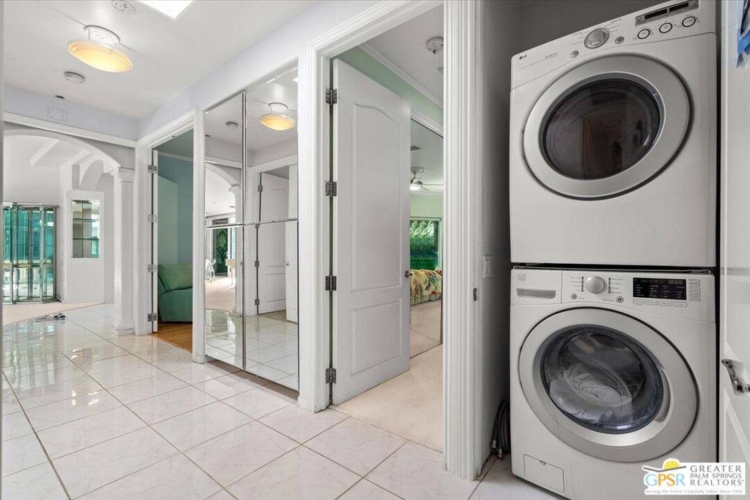 875 Tamarisk Road Palm Springs, CA 92262 - Photo 24 of 55 a view of a hallway with washer and dryer