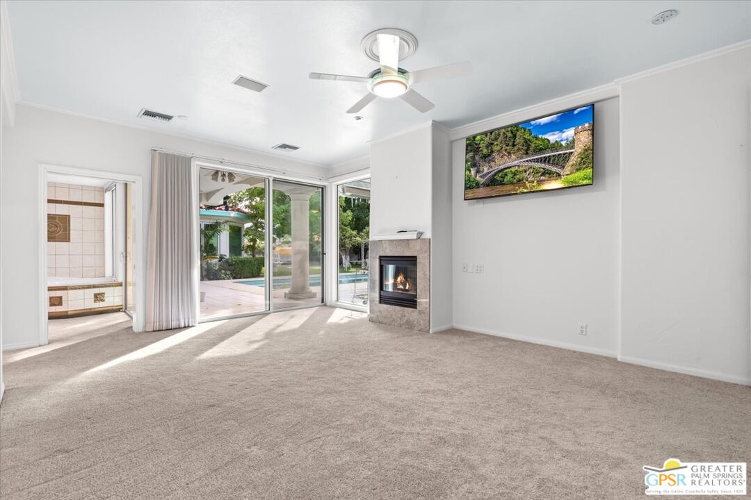 875 Tamarisk Road Palm Springs, CA 92262 - Photo 28 of 55 a view of an empty room with a fireplace
