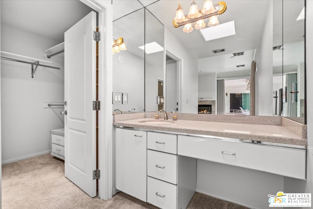 875 Tamarisk Road Palm Springs, CA 92262 - Photo 29 of 55 a spacious bathroom with a granite countertop sink mirror and a toilet