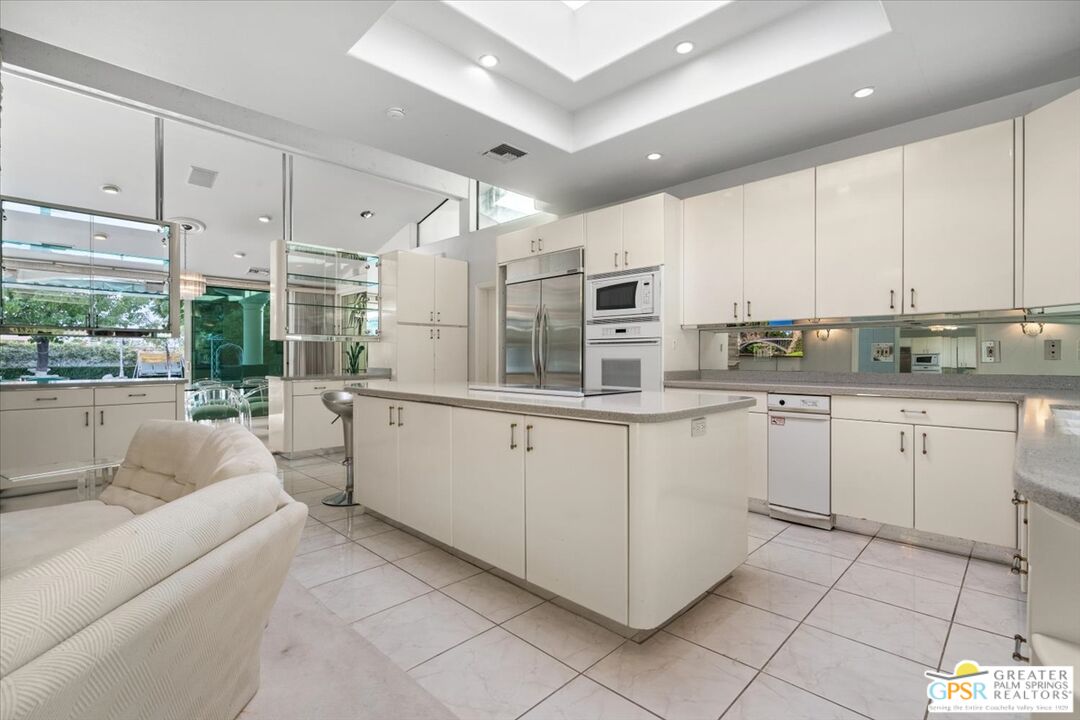 875 Tamarisk Road Palm Springs, CA 92262 - Photo 3 of 55 a kitchen with cabinets and window