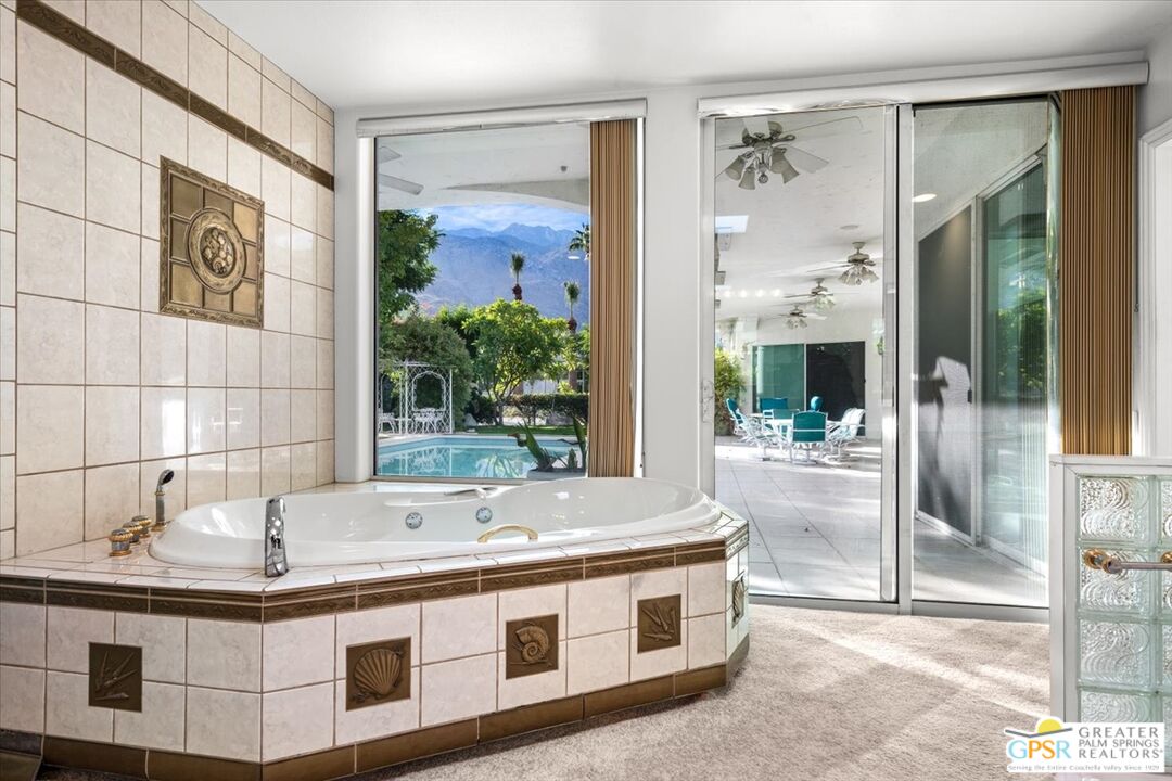 875 Tamarisk Road Palm Springs, CA 92262 - Photo 31 of 55 a spacious bathroom with a tub and a sink