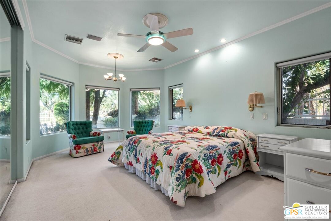 875 Tamarisk Road Palm Springs, CA 92262 - Photo 39 of 55 a bedroom with a bed and large windows