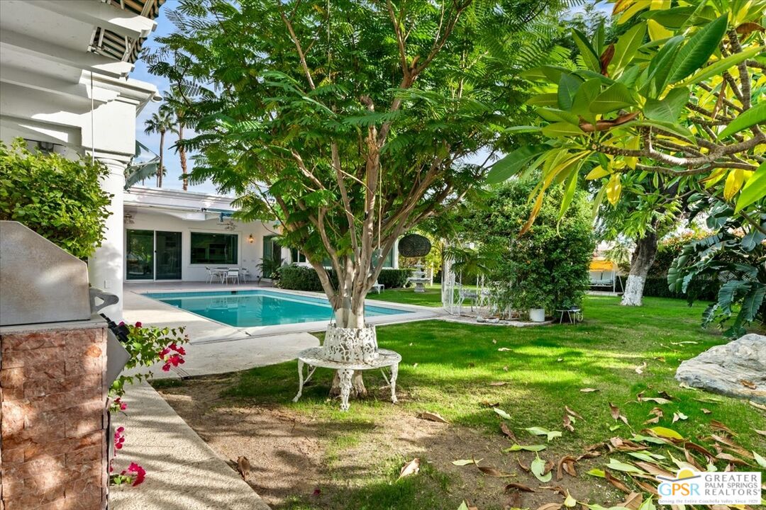 875 Tamarisk Road Palm Springs, CA 92262 - Photo 41 of 55 a garden with trees in front of it