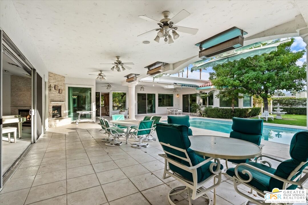 875 Tamarisk Road Palm Springs, CA 92262 - Photo 48 of 55 a view of a patio with table and chairs