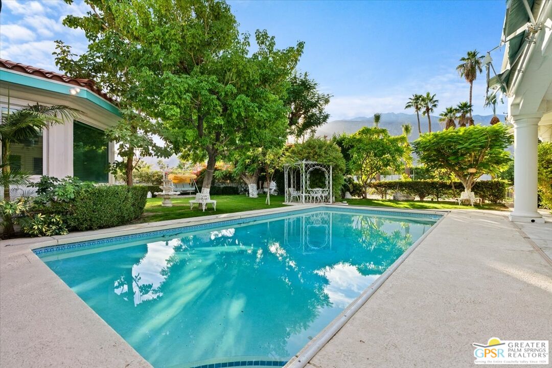 875 Tamarisk Road Palm Springs, CA 92262 - Photo 5 of 55 a view of a swimming pool with a patio