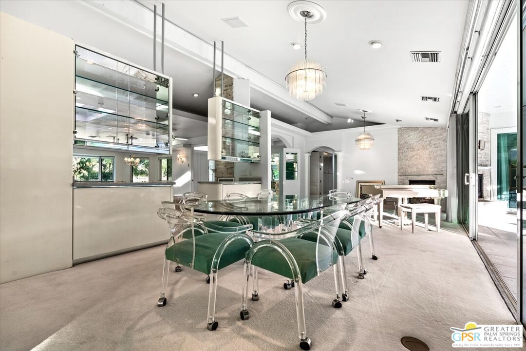 875 Tamarisk Road Palm Springs, CA 92262 - Photo 6 of 55 a room with lots of chairs and mirrors