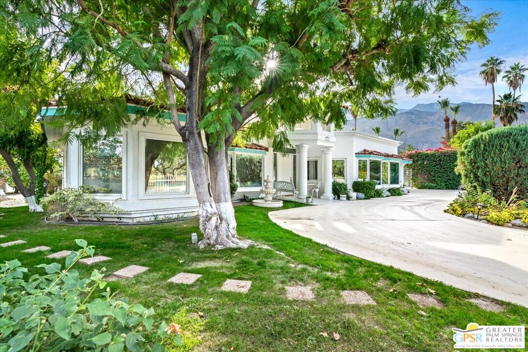 875 Tamarisk Road Palm Springs, CA 92262 - Photo 9 of 55 a front view of a house with a yard