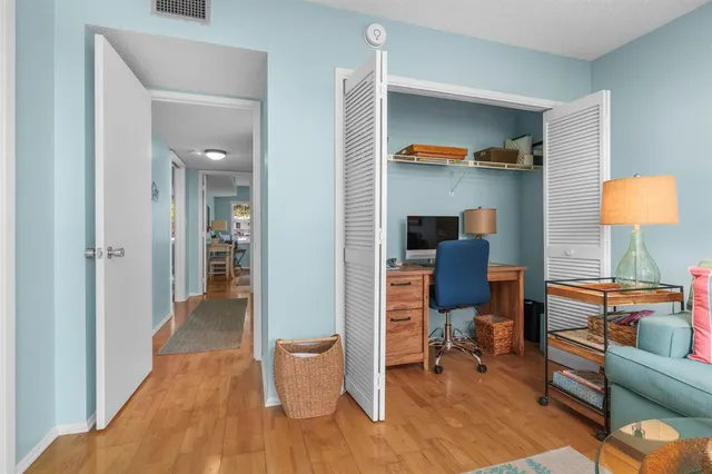 a reading room with furniture and a wooden floor