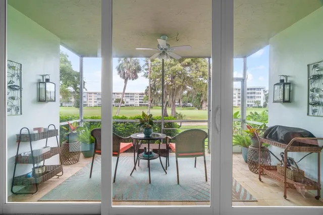 a living room with furniture and a floor to ceiling window