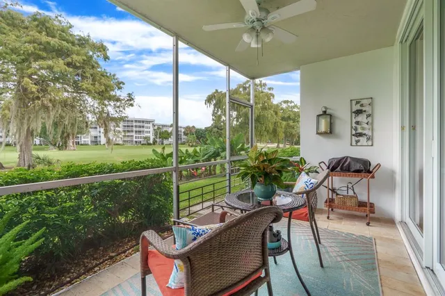 a view of a porch with furniture and a yard
